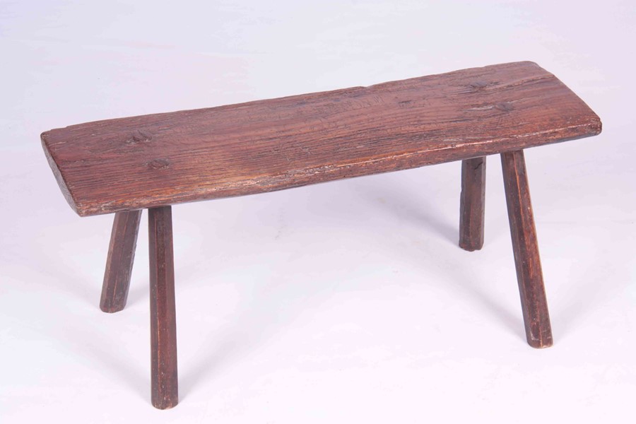 A PRIMITIVE 18TH CENTURY ELM PIG BENCH raised on four chamfered legs 77.5cm wide 24cm deep 35cm - Image 2 of 5