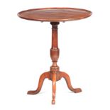 A GEORGE III MAHOGANY TILT TOP TABLE with dished top above a turned stem; standing on a cabriole