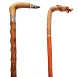 TWO LATE 19TH CENTURY HORN HANDLED WALKING CANES the first modelled as a wolf's head with inset