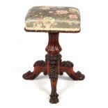 AN EARLY 19TH CENTURY OAK PIANO STOOL IN THE MANNER OF GILLOWS the elaborate carved base decorated