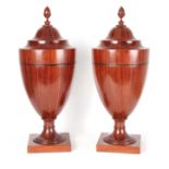 A PAIR OF GEORGE III SHERATON DESIGN MAHOGANY CUTLERY URNS the boxwood and ebony strung segmented