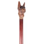 A LATE 19TH CENTURY BLACK FOREST DOG'S HEAD WALKING STICK realistically modelled with glass inset