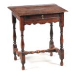 A LATE 17TH CENTURY OAK SIDE TABLE OF SMALL SIZE the overhung top above a moulded edge frieze drawer