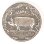 AN EARLY 20TH CENTURY SILVERED MEDAL FOR THE NATIONAL PIG BREEDERS ASSOCIATION awarded to R.P.