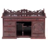 A 20TH CENTURY ORIENTAL CARVED TABLE TOP DESK with pierced gallery back above a greek key carved