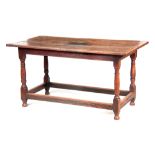 AN EARLY 18TH CENTURY OAK REFECTORY TABLE OF SMALL SIZE with cleated plank top above a joined base