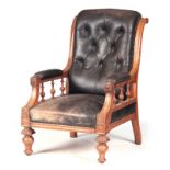 A LATE 19TH CENTURY OAK FRAMED LEATHER LIBRARY CHAIR with button upholstered back and sweeping
