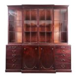 A GOOD GEORGE III HEPPLEWHITE MAHOGANY BREAKFRONT BOOKCASE with moulded cornice, having fluted