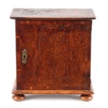 A LATE 17TH CENTURY ELM SPICE CABINET with crossbanded burr veneered hinged door enclosing an