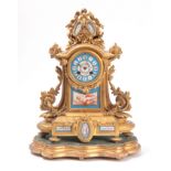A LATE 19TH CENTURY FRENCH ORMOLU AND PORCELAIN PANELLED MANTEL CLOCK the case surmounted by a