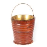 AN EARLY 19TH CENTURY RIBBED MAHOGANY OYSTER BUCKET with fold-down brass handle and liner, of