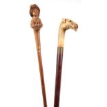 A LATE 19TH CENTURY CONTINENTAL WALKING STICK WITH BLACK FOREST CARVED WALNUT HANDLE depicting a