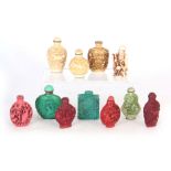 A COLLECTION OF TEN ORIENTAL COLOURED SNUFF BOTTLES AND A SMALL FIGURE OF A MAN