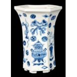 A CHINESE BLUE AND WHITE HEXAGONAL SHAPED TRUMPET VASE, decorated with antiquities raised on shallow