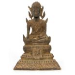 A TIBETAN BRONZE SEATED BUDDHA 14cm high.