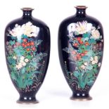 A PAIR OF EARLY 20TH CENTURY JAPANESE CLOISONNE VASES with dark blue ground and foliate decoration