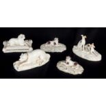 A COLLECTION OF FIVE SMALL CONTINENTAL PORCELAIN FIGURES OF DOGS comprising a pair of recumbent