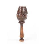 A 19TH CENTURY WALNUT BLACK FORREST NOVELTY NUT-CRACKER FORMED AS A GENTLEMANS HEAD mounted on a