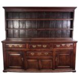 A GOOD EARLY 18TH CENTURY OAK WELSH DRESSER the rack with moulded cornice above three tapering