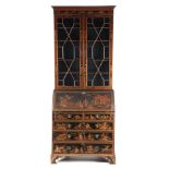 A LATE 19TH CENTURY JAPANNED CHINOISERIE BUREAU BOOKCASE the moulded cornice above a pair of