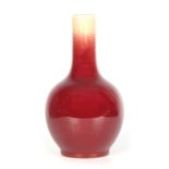A 19TH CENTURY CHINESE SANG DE BOEUF GLAZED VASE of bulbous shape - drilled for a lamp fitting