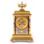 A LATE 19TH CENTURY FRENCH BRASS AND CHAMPLEVE ENAMEL MANTEL CLOCK the case surmounted by an urn