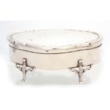 A GEORGE V LARGE SHAPED OVAL SILVER JEWELLERY CASKET with decorated top and lined interior raised on