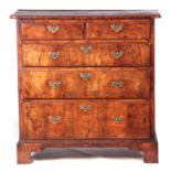 A GEORGE I FIGURED WALNUT CHEST OF DRAWERS of superb colour and patina, the quarter veneered top
