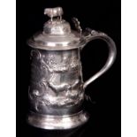 A LARGE GEORGE II SILVER LIDDED TANKARD WITH LATER EMBOSSED DECORATION the domed hinged lid with