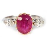A LADIES RUBY AND DIAMOND RING the oval ruby set in yellow gold flanked by two marquise diamonds, on