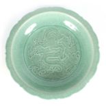 AN EARLY CHINESE UNUSUALLY LARGE PALE GREEN CRACKLE GLAZE CELADON SHALLOW BOWL with scallop-edge
