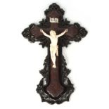 A WELL CARVED 19TH CENTURY IVORY FIGURE OF CHRIST, PROBABLY GERMAN on an ebony and walnut carved and