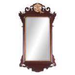 A 19TH CENTURY GEORGE III STYLE MAHOGANY HANGING MIRROR with a shaped frame having gilt carved