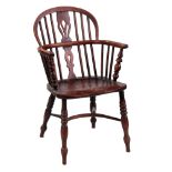 A 19TH CENTURY ASH AND ELM WINDSOR CHAIR with pierced back splat and saddle seat; standing on ring