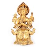 AN EARLY GILT BRONZE BUDDHA depicting a seated deity 12cm high.