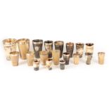 A COLLECTION OF NINETEEN LATE 19TH CENTURY SILVER MOUNTED HORN BEAKERS of tapering form with glass