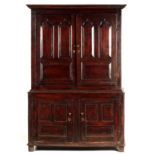 A MID 18TH CENTURY OAK PRESS CUPBOARD with moulded edge cornice above a pair of doors with arched