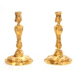 A PAIR OF 18TH CENTURY GILT BRASS ROCOCO CANDLESTICKS 30.5cm high