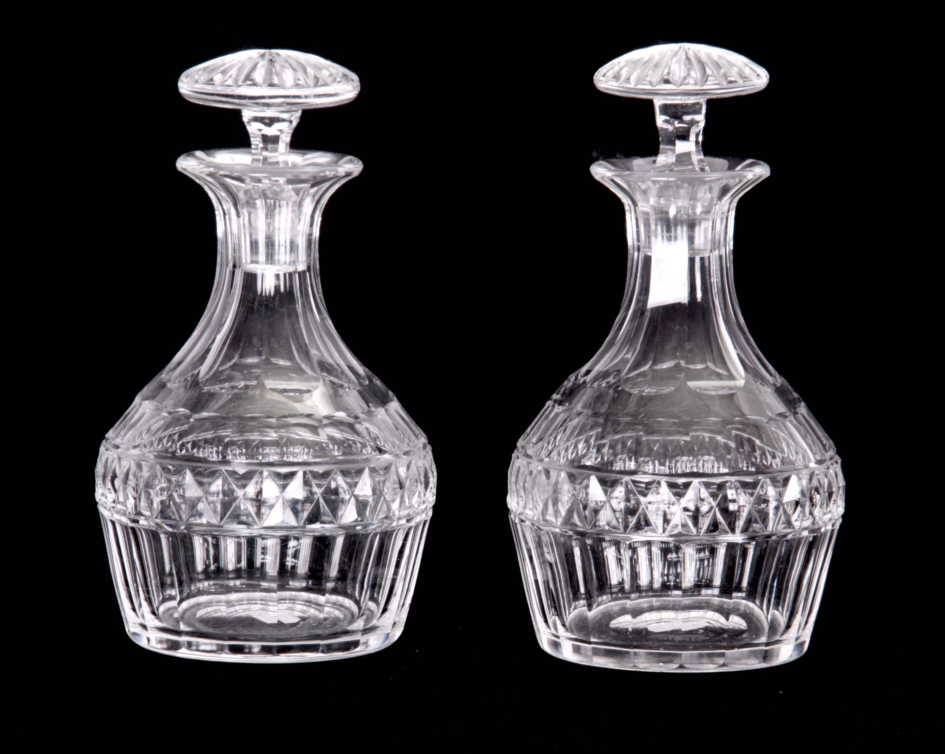 A PAIR OF GEORGE III DESIGN CUT GLASS DECANTERS AND STOPPERS with blade and diamond banded mallet