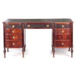 WARING AND GILLOW AN EARLY 20TH CENTURY MAHOGANY DESK with green leathered top above a shaped