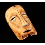 AN AFRICAN TRIBAL CARVED BONE MASK-HEAD ANKLE/WRIST BAND 9.5cm overall