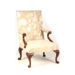 AN 18TH CENTURY IRISH STYLE GAINSBOROUGH CHAIR with unusual scrolled arms and upholstered shaped