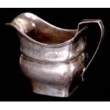 A GEORGE III IRISH SILVER CREAM JUG of rectangular moulded form with bright-cut banded decoration