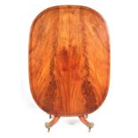 A REGENCY FLAME MAHOGANY TILT-TOP TABLE with ebony inlays, on a turned column support mounted on a