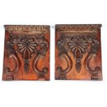 TWO LATE REGENCY MAHOGANY CARVED PANELS with large Fleur de lis centres, swagged and grape