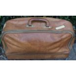 Vintage Leather Travel Bag with shipping and other stickers, Leather carrying handle and brass
