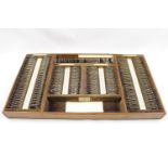 OPTICIANS CASE, mahogany case containing set of opticians lenses by The American Optical Co. of