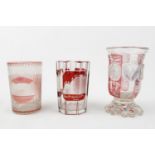 THREE 19TH CENTURY BOHEMIAN SPA GLASSES, each pink or ruby flashed and engraved with architectural
