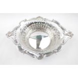 Fine Edwardian Silver Pierced fruit bowl of Diamond form with figural handles supported on scroll