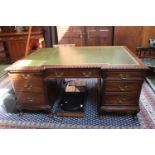 Edwardian Mahogany breakfront Pedestal desk with green Leather inset top over brass drop handles and